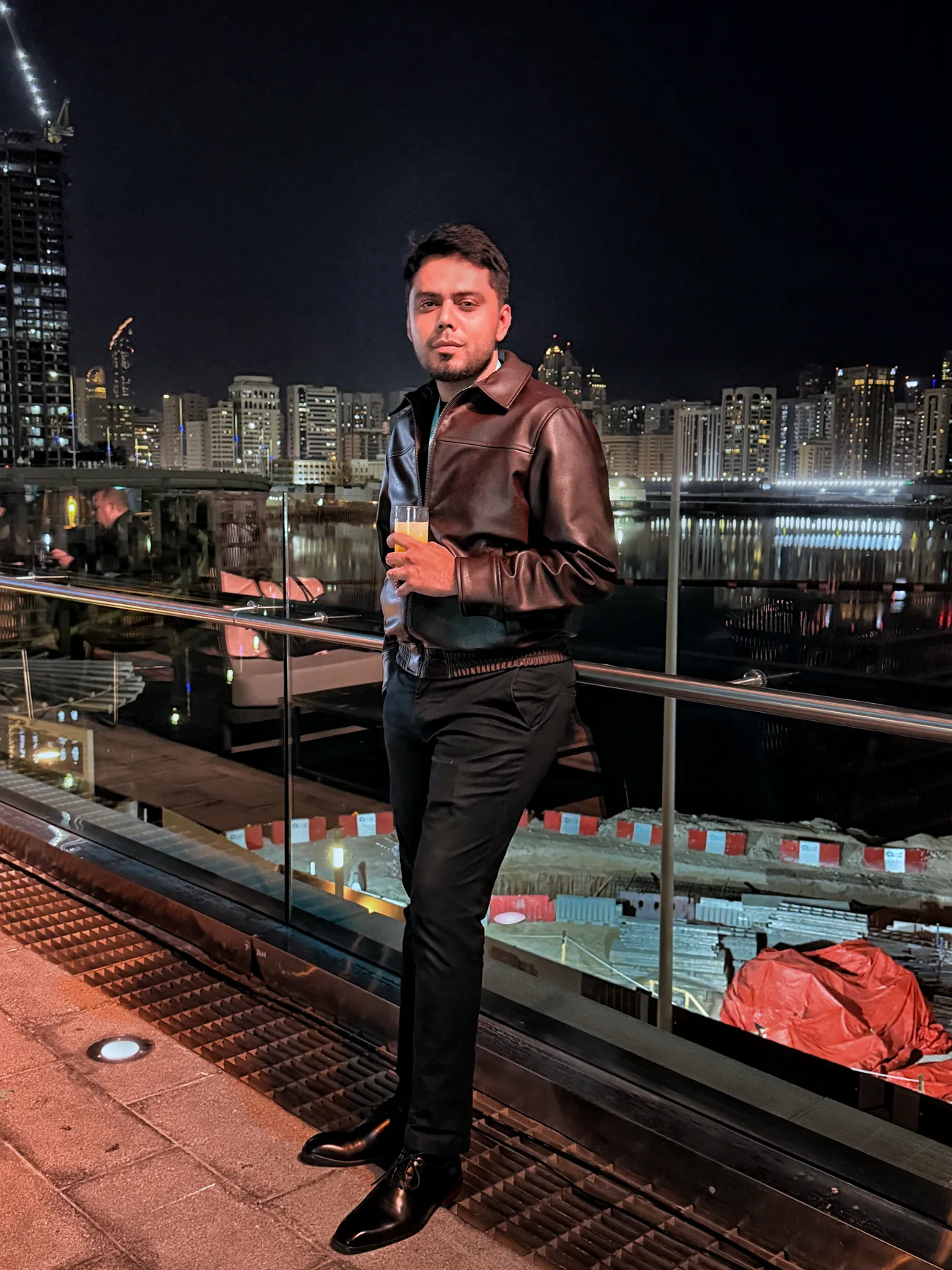 Taimour Tariq at an ADGM LINK networking event in Abu Dhabi, beside the waterfront at night